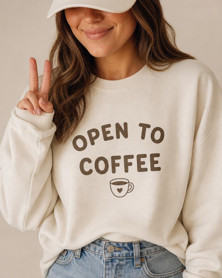 Person wearing an OPEN TO COFFEE sweatshirt
